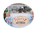 two little girls eating ice cream cones in front of Tyler's booth