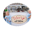 Every kid loves Tyler's Ice Cream! two little girls eating ice cream cones in front of Tyler's booth