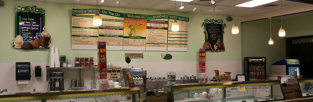 tables and chairs with cartoon surfing turtle mural on wall